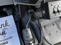 A close-up view of the gear shift lever in a 2016 Ford F-550 truck's cabin