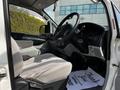 Interior view of a 2003 Mitsubishi 7 Passenger Van showing a driver’s seat, steering wheel, and dashboard with visible controls and seat upholstery