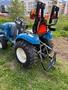 A blue 2021 LS XJ2025H tractor with large rear tires and a hitch attachment in the back