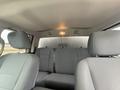 Interior view of a 2016 RAM 1500 showing front bucket seats and rear bench seat with gray upholstery and an overhead light