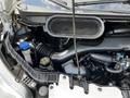 2015 Ford Transit engine compartment featuring the air intake system with various components including hoses and a coolant reservoir