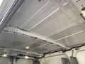 The interior ceiling of a 2017 Ford Transit cargo van showing a white finish with several light fixtures and a few panels visible