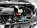 Close-up of the engine compartment of a 2020 Mercedes-Benz Sprinter showcasing the air intake system coolant reservoir and various engine components