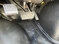 The floor area of a 2014 Chevrolet Express showing the accelerator pedal and brake pedal in close-up detail