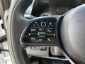 Close-up of the steering wheel controls in a 2020 Mercedes-Benz Sprinter with buttons for cruise control and adjustments