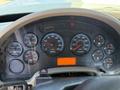 The dashboard of a 2013 International 7400 featuring various gauges for RPM speed water temperature fuel voltmeter and trip information