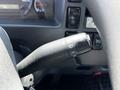 Close-up of the turn signal lever in a 2016 Isuzu NPR with various controls and indicators visible
