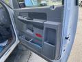 The image shows the interior door panel of a 2009 Dodge Ram 5500 featuring a black plastic handle and storage compartments