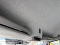 The interior ceiling of a 2016 Mercedes-Benz Sprinter featuring a gray fabric finish with a small overhead storage compartment and light control panel