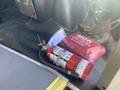 A 2020 Chevrolet Express van interior featuring a red fire extinguisher and a first aid kit on the floor