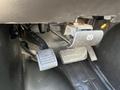 Close-up of the pedals in a 2014 Chevrolet Express showing the accelerator pedal brake pedal and a foot-operated parking brake