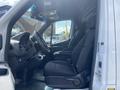 Interior view of a 2025 Mercedes-Benz Sprinter showing two front seats and the dashboard with controls and a steering wheel