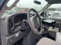 Interior view of a 2006 Ford Econoline showing the steering wheel dashboard and control panel