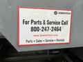 2023 Mack Granite with a red and white service information sticker displaying a phone number and website for parts and service