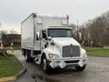 A white 2017 Kenworth T370 box truck with chrome accents and a large cargo area parked on a road