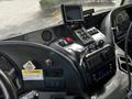 Interior dashboard of a 2012 Autocar Xpert featuring various controls screens and a dashboard display with keys in the ignition