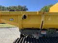 A yellow 2022 TerraMac tracked dump with a large container and a secure latch mechanism on the side