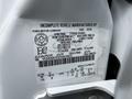 Close-up of a white 2007 Ford F-550 VIN sticker with vehicle specifications including weight ratings and tire sizes