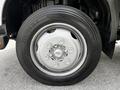 Close-up of a silver wheel on a 2018 Hino 195 with a black tire featuring the size 225/70R19.5 and visible lug nuts around the hub