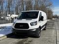 A white 2018 Ford Transit van with a cargo-style design and black trim is parked on a road