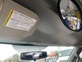 Interior view of a 2017 Chevrolet Express showing the overhead console with warning label and two mirrors mounted on the ceiling