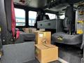 Interior of a 2009 Spartan Gladiator showing two black seats and several cardboard boxes on the floor