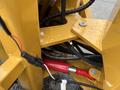 Close-up of a 2024 AGT Industrial KRW23 Mini Loader's hydraulic system showing hoses and mechanical components with droplets of water on the surface
