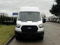 Front view of a white 2021 Ford Transit van with a black grille showcasing the Ford logo and large windshield