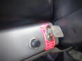 A close-up of a 2005 Ford F-750 ignition switch and emergency valve with a label indicating the valve is in the off position