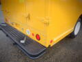 A yellow 2008 Freightliner MT45 Chassis with a boxy rear design featuring red and white lights and a textured black step on the back