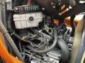 Close-up of the engine compartment of a 2001 Agco ST40 showing various components including a fuse box and engine parts with connected wires and hoses