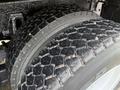 Close-up of a heavy-duty tire from a 2016 International 7400 featuring a textured tread design and visible wear on the rubber surface