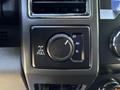 A close-up of the dial and control panel from the interior of a 2020 Ford F-350 SD featuring a four-wheel drive selector and a pull lever