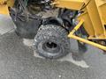 A 2014 Vermeer Corporation Sweep Stump Cutter with a sturdy tire showing deep treads and a rugged exterior designed for rough terrain and stump removal