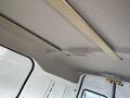 Interior view of a 2010 Ford Transit Connect showing the ceiling and overhead storage bar