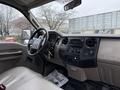 Interior view of a 2008 Ford F-250 SD featuring a beige dashboard modern controls and a steering wheel with a simple design