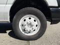 A close-up view of a white 2013 Ford Econoline tire showcasing the wheel rim and tire tread pattern