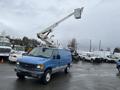 A blue 2006 Ford Econoline van with a raised extendable bucket on top for work purposes
