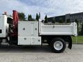 A 2008 International 4300 dump truck featuring a red hydraulic crane on the side and multiple storage compartments on the body
