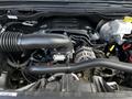 A 2019 RAM 1500 engine with various components including the intake manifold alternator and hoses prominently visible