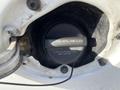 Close-up of a fuel cap on a 2014 Chevrolet Express with instructions to tighten until one click and a note about the service engine light