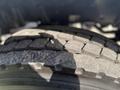 Close-up of a worn tire from a 2015 Peterbilt 337 showing tread patterns and signs of usage