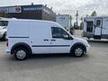 A white 2010 Ford Transit Connect van with sliding side doors and a boxy design parked in a lot