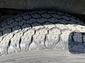 Close-up of a textured tire tread on a 2016 GMC Savana showing detailed patterns and grooves designed for traction on various surfaces