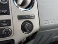 The dashboard of a 2016 Ford F-350 SD featuring climate control knobs buttons for auxiliary power and a central air vent