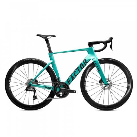 A teal 2026 Factor MONZA Shimano carbon performance road bike with a sleek design, aerodynamic frame, and disc brakes