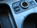 The console of a 2015 Ford Escape featuring heated seat controls and a cracked area around the gear shift