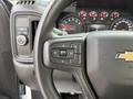 Close-up of the steering wheel controls of a 2024 Chevrolet Silverado 1500 with buttons for cruise control settings