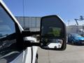 A close-up of the side mirror of a 2017 Ford F-350 SD showing the reflective surface and the truck’s body