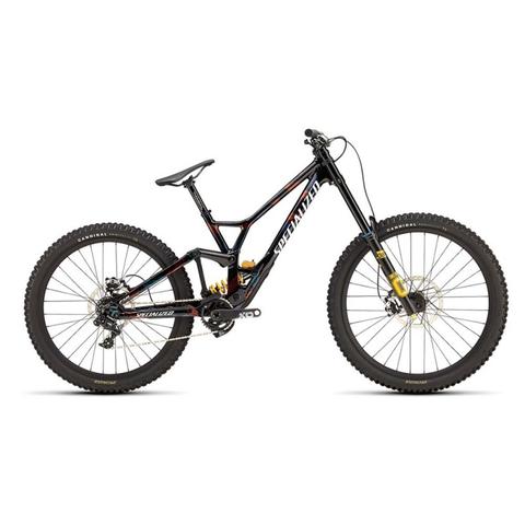 A 2025 Specialized Demo Race Mountain Bike with a black and red frame featuring large knobby tires, a curved seat, and a dual suspension setup